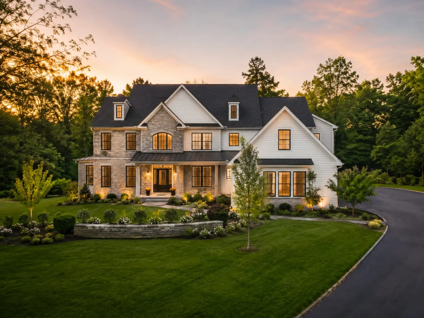 New construction custom home in Buckingham PA with stone exterior, wooded backdrop, landscaped yard, and private driveway