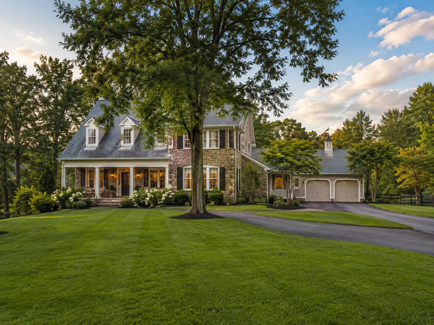 Beautiful stone home with manicured lawn and mature trees in Buckingham Township, PA.