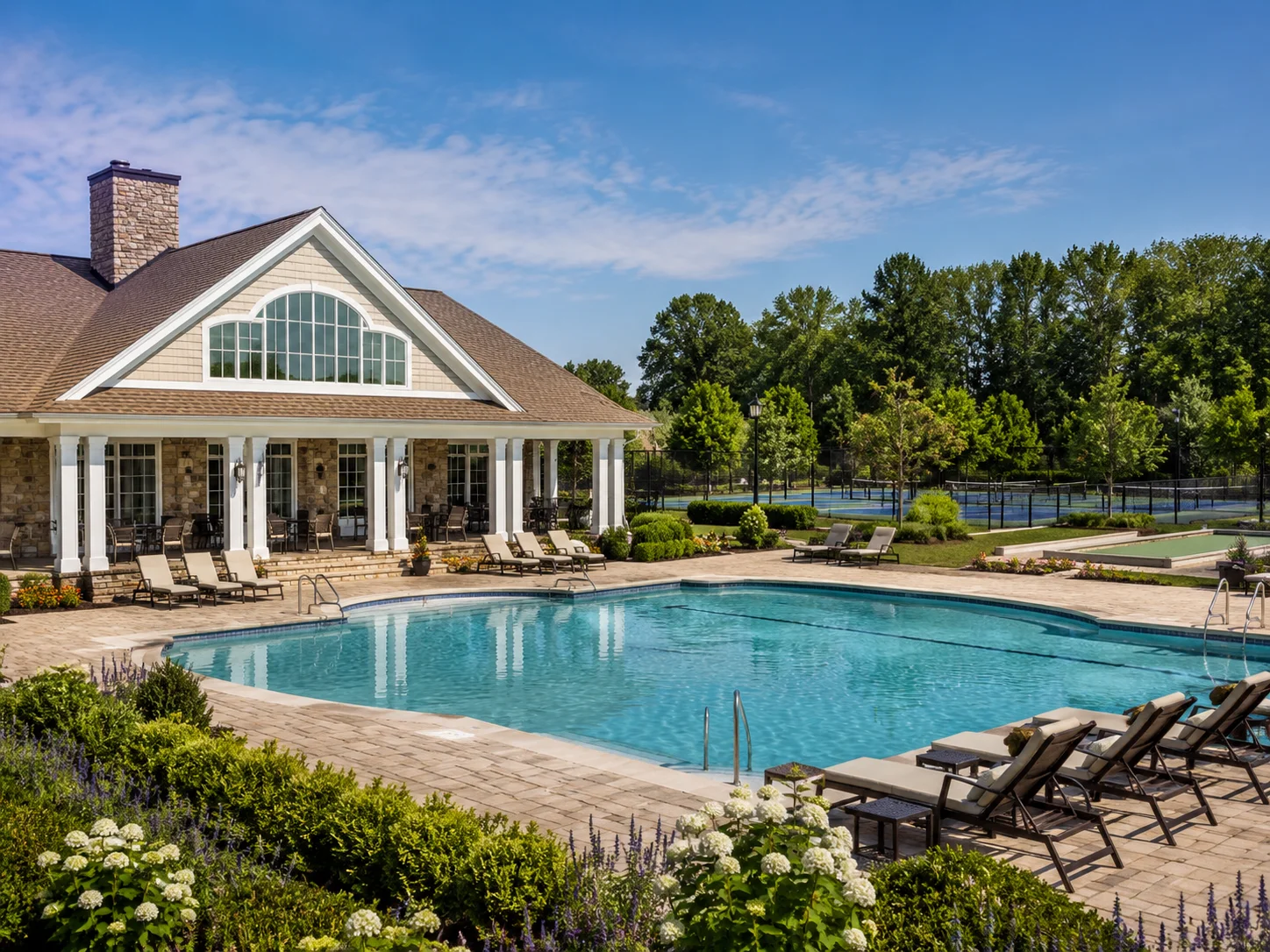 Outdoor pool, clubhouse and recreation courts in a Bucks County 55+ community.