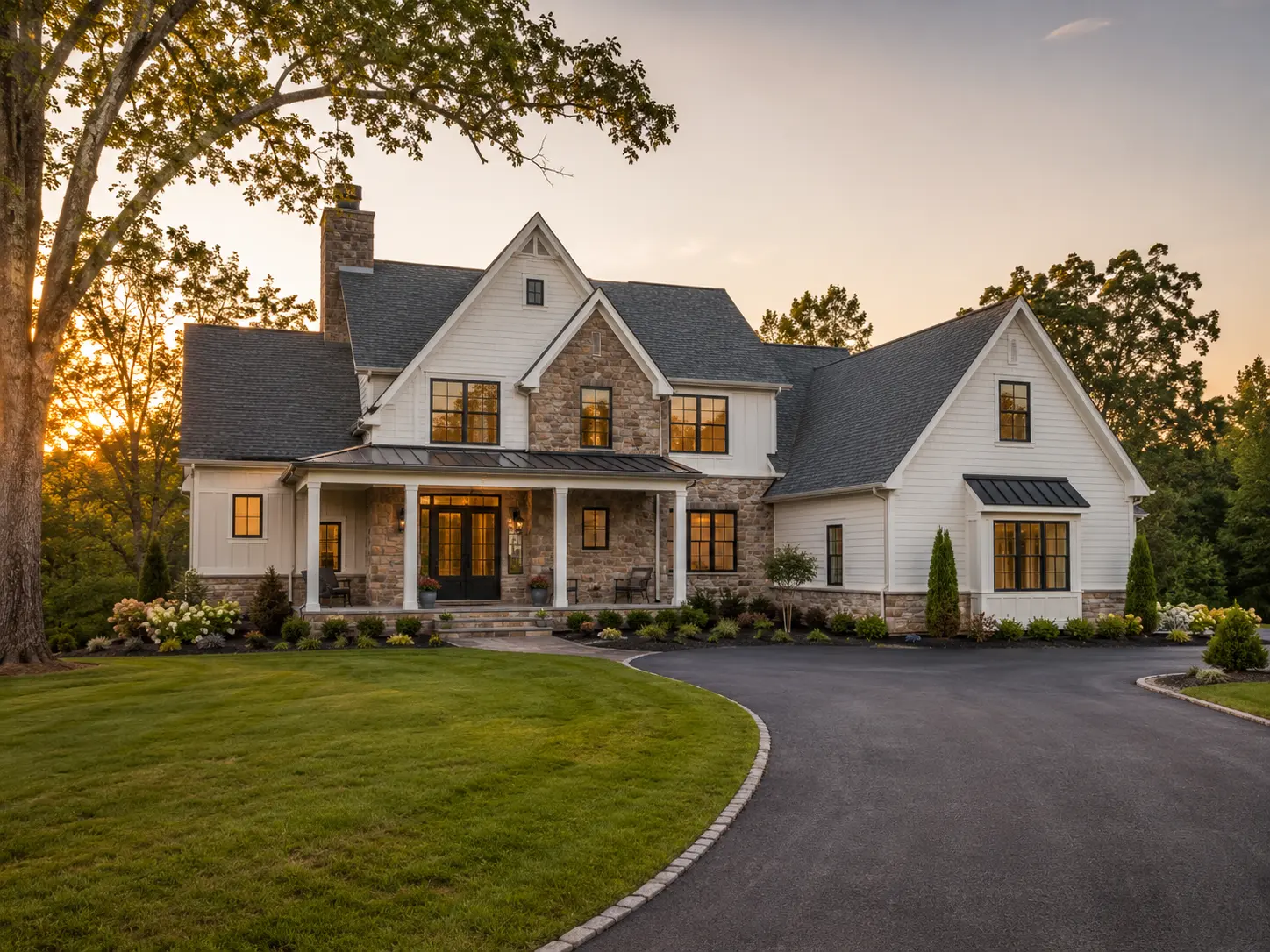 New construction home in New Hope PA with stone exterior, white siding, landscaped yard, and mature trees at sunset.