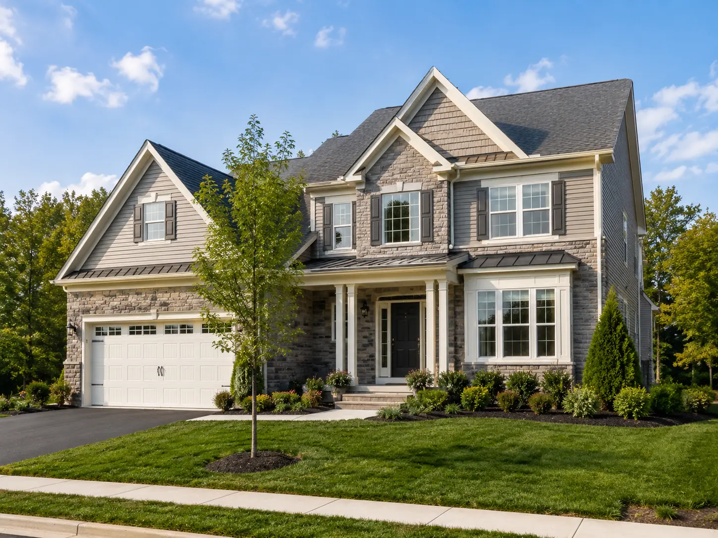 Newly built single-family home near Chalfont with stone exterior, covered front entry, manicured lawn, and upscale landscaping