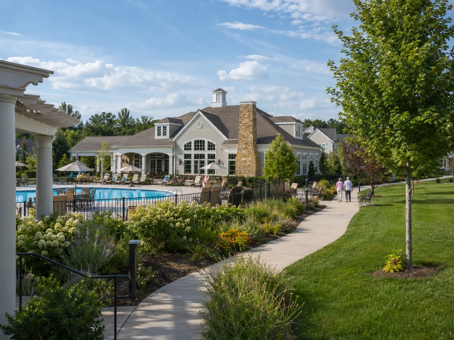 Clubhouse, pool, walking path, and landscaping at a Washington Crossing 55+ community