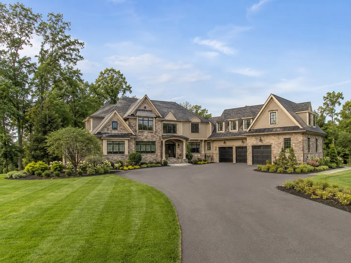 Luxury new construction estate home in Washington Crossing with landscaped lawn and wide driveway