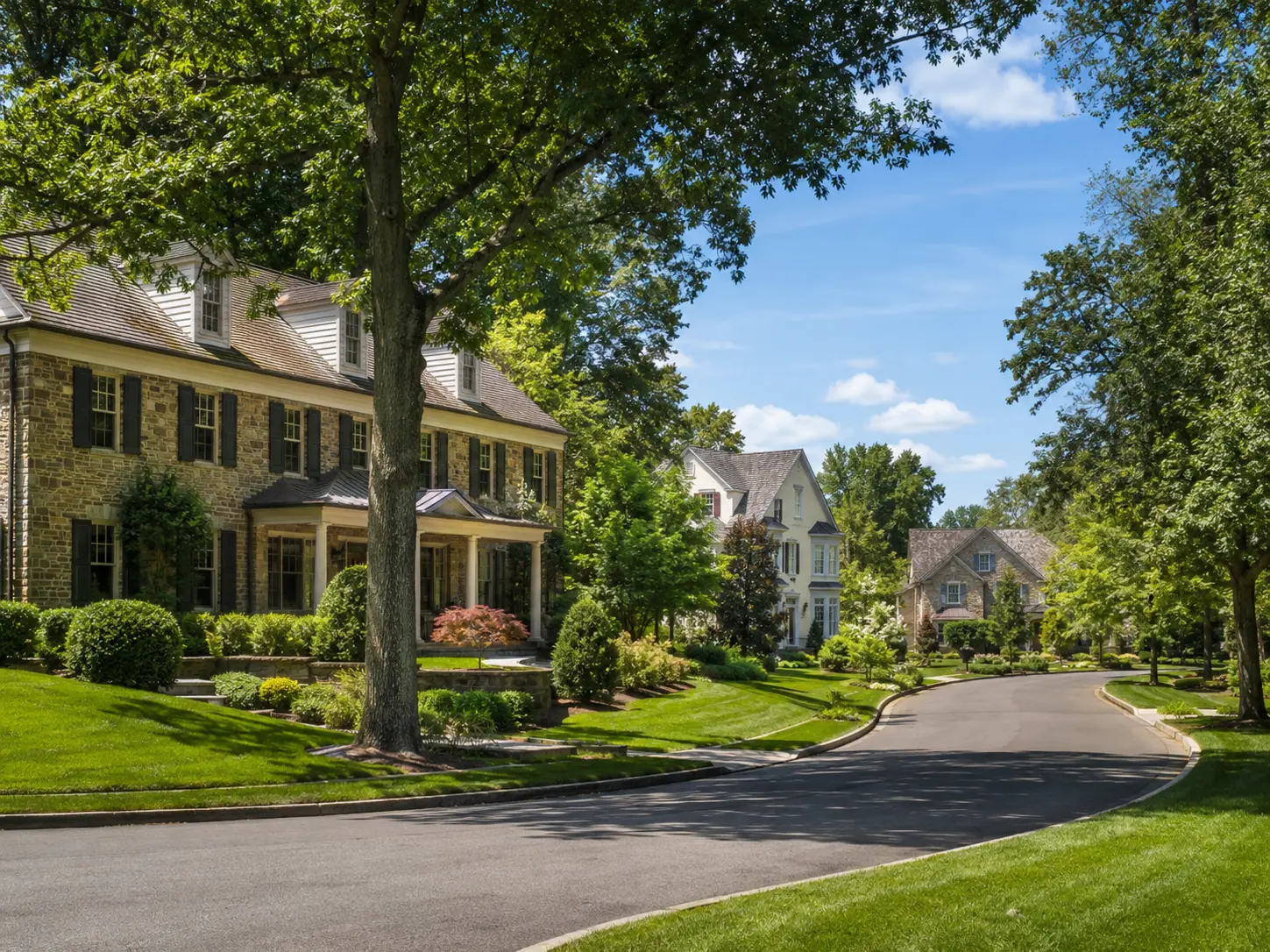 Upscale Yardley neighborhood street with luxury homes and mature landscaping